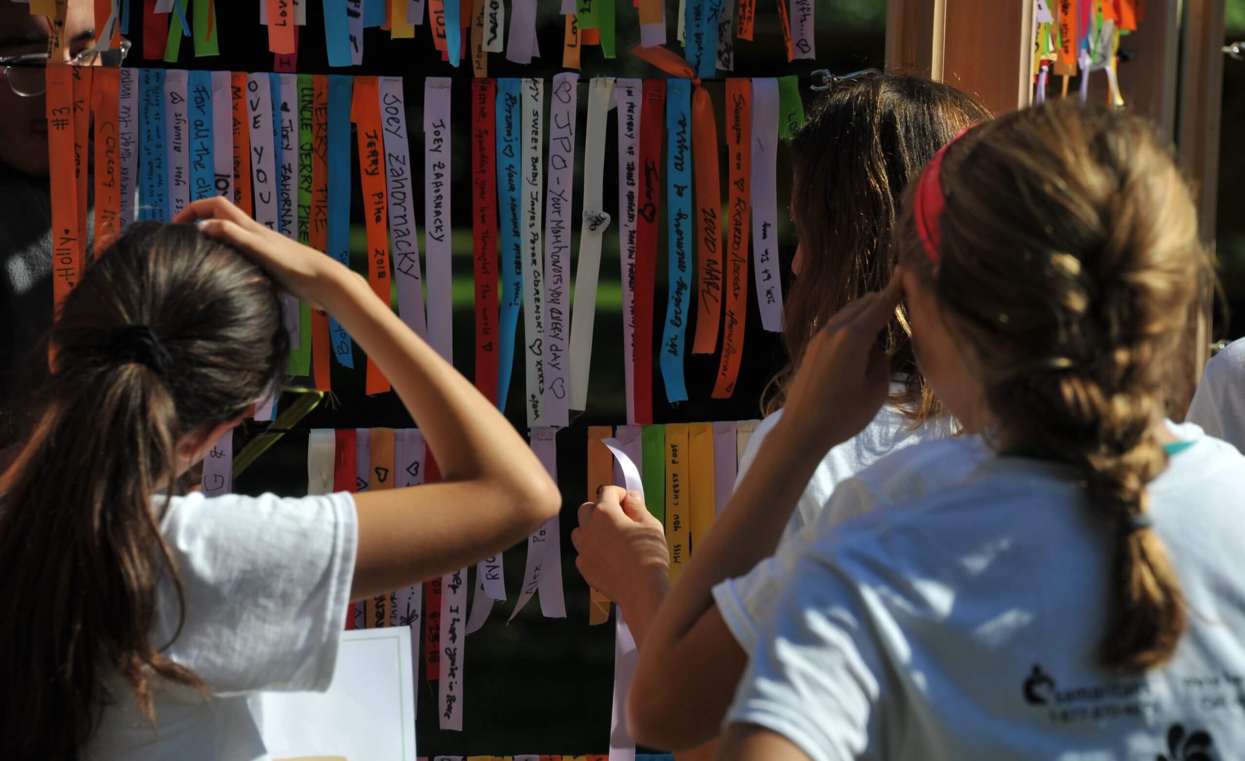 People contemplating the Ribbon Wall at the Samaritans 5K