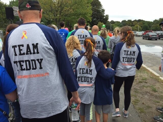 Team Teddy walking in the 5K race. The backs of their shirts read Team Teddy.