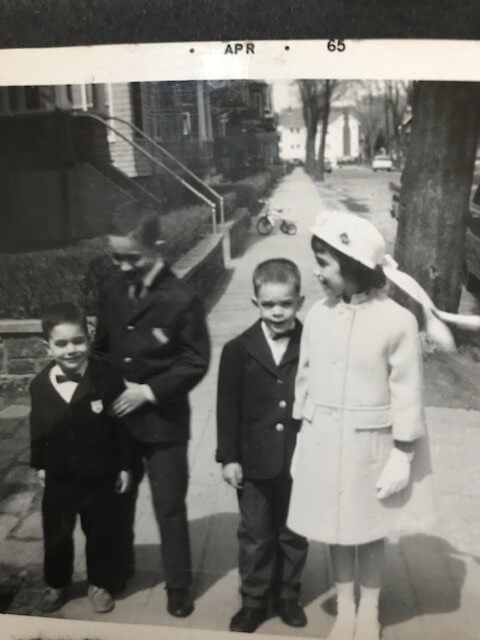 black and white photo of four children in formal clothes