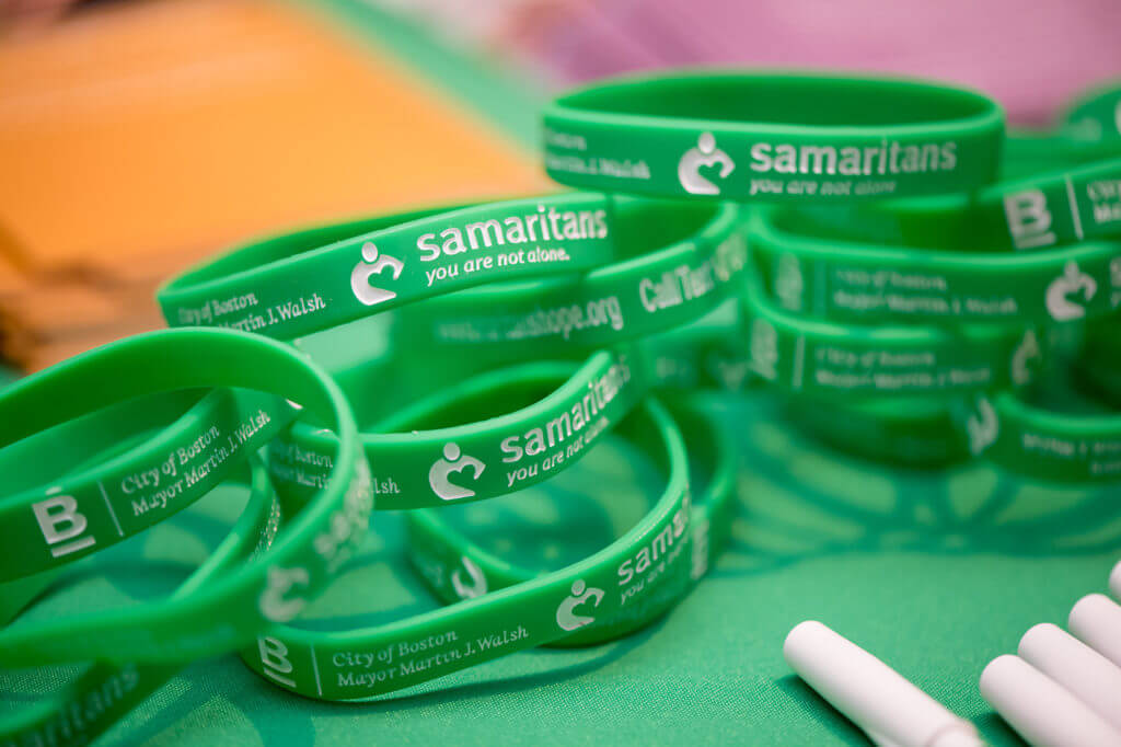 A close up of a table with Samaritans rubber bracelets.