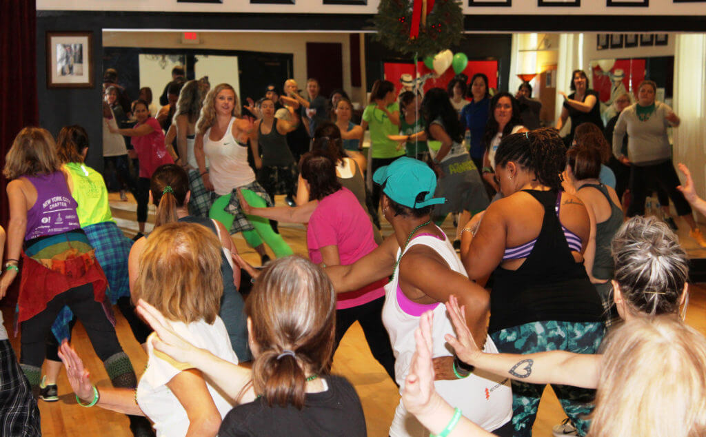 A group of individuals doing a Zumba class.