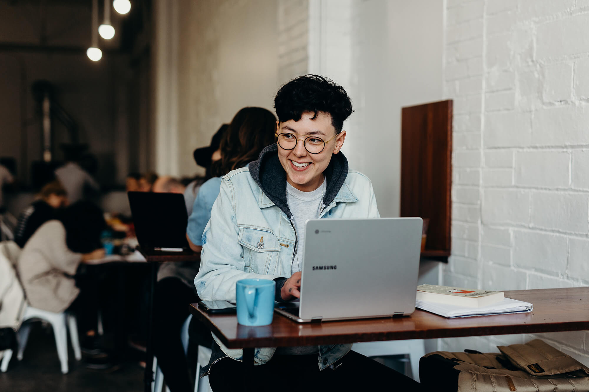 A person in a cafe on a laptop.