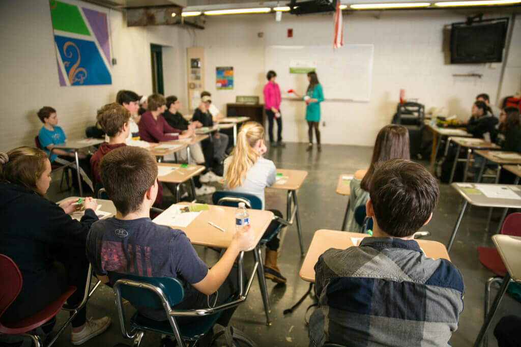 A classroom full of students engaged in a school suicide prevention workshop