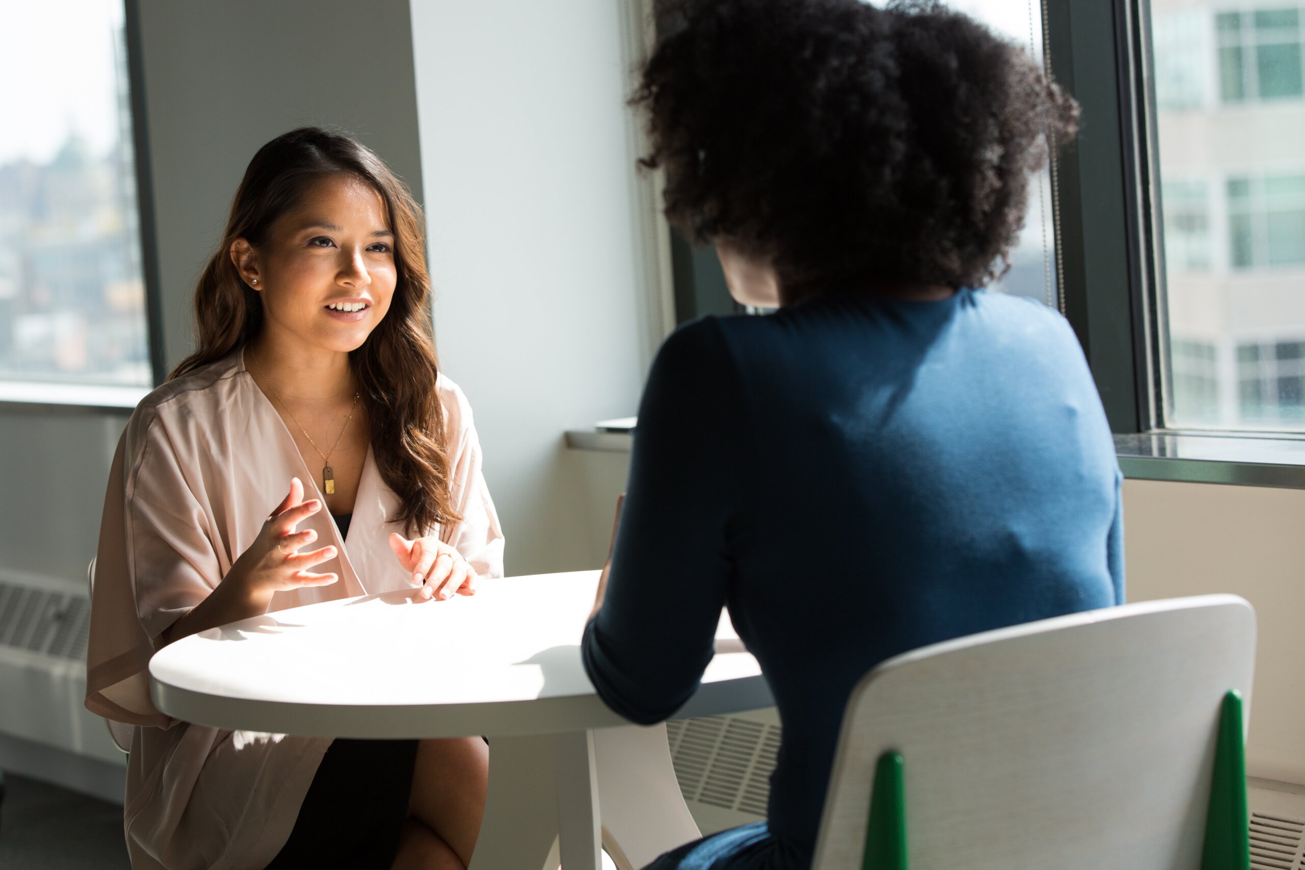 two women of color in work meeting