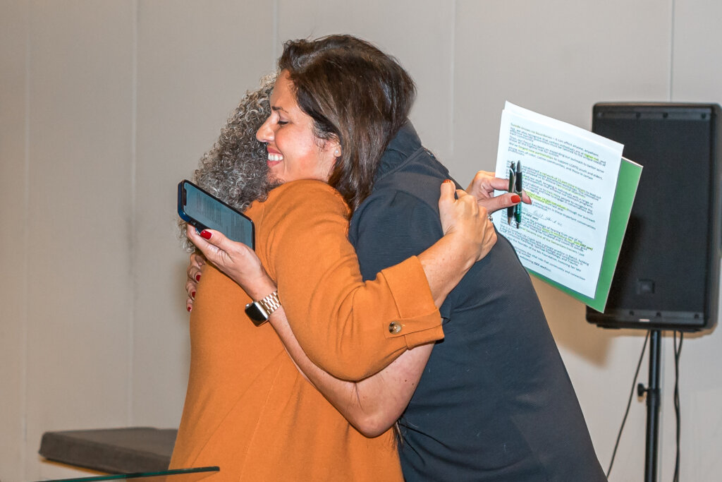 Sissi and Kathy Marchi, Samaritans CEO and President, share a hug.