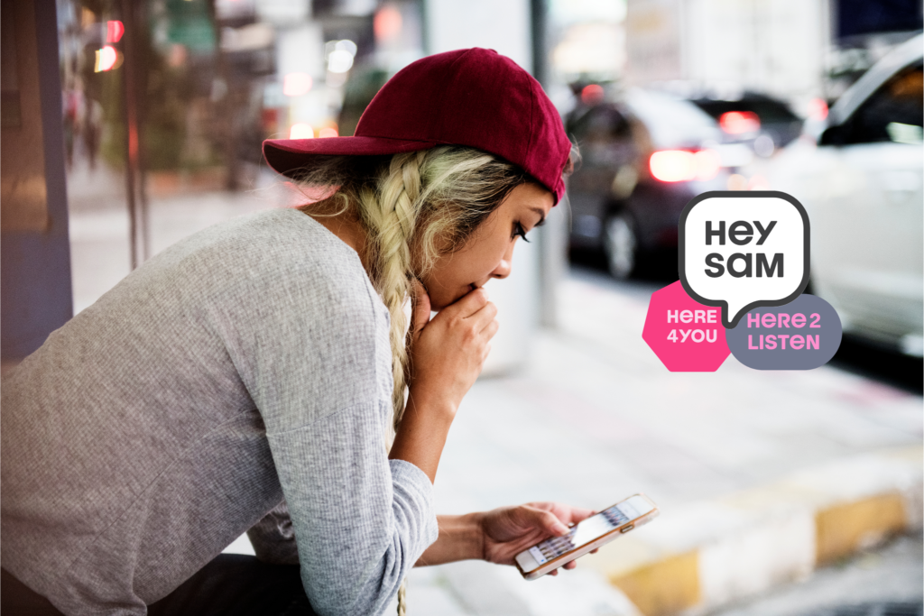 teen sitting outside texting