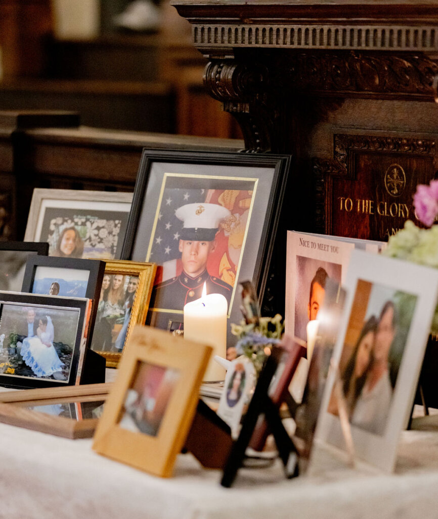 Framed photographs and candles displayed on the memorial table.
