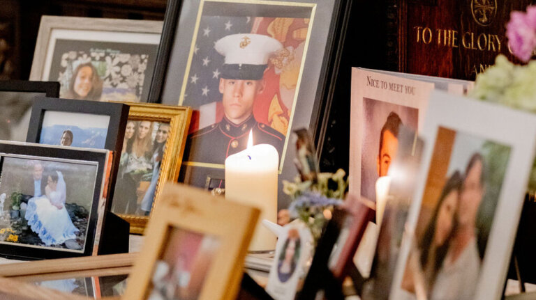 Framed photographs and candles displayed on the memorial table.