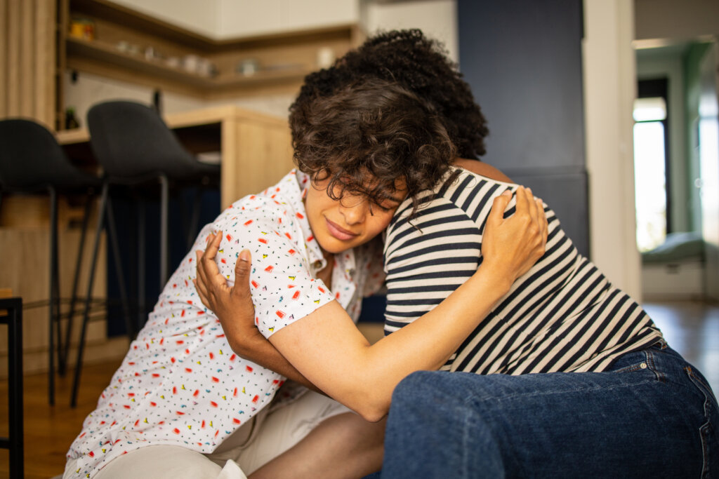 A woman comforting her suicidal partner in crisis