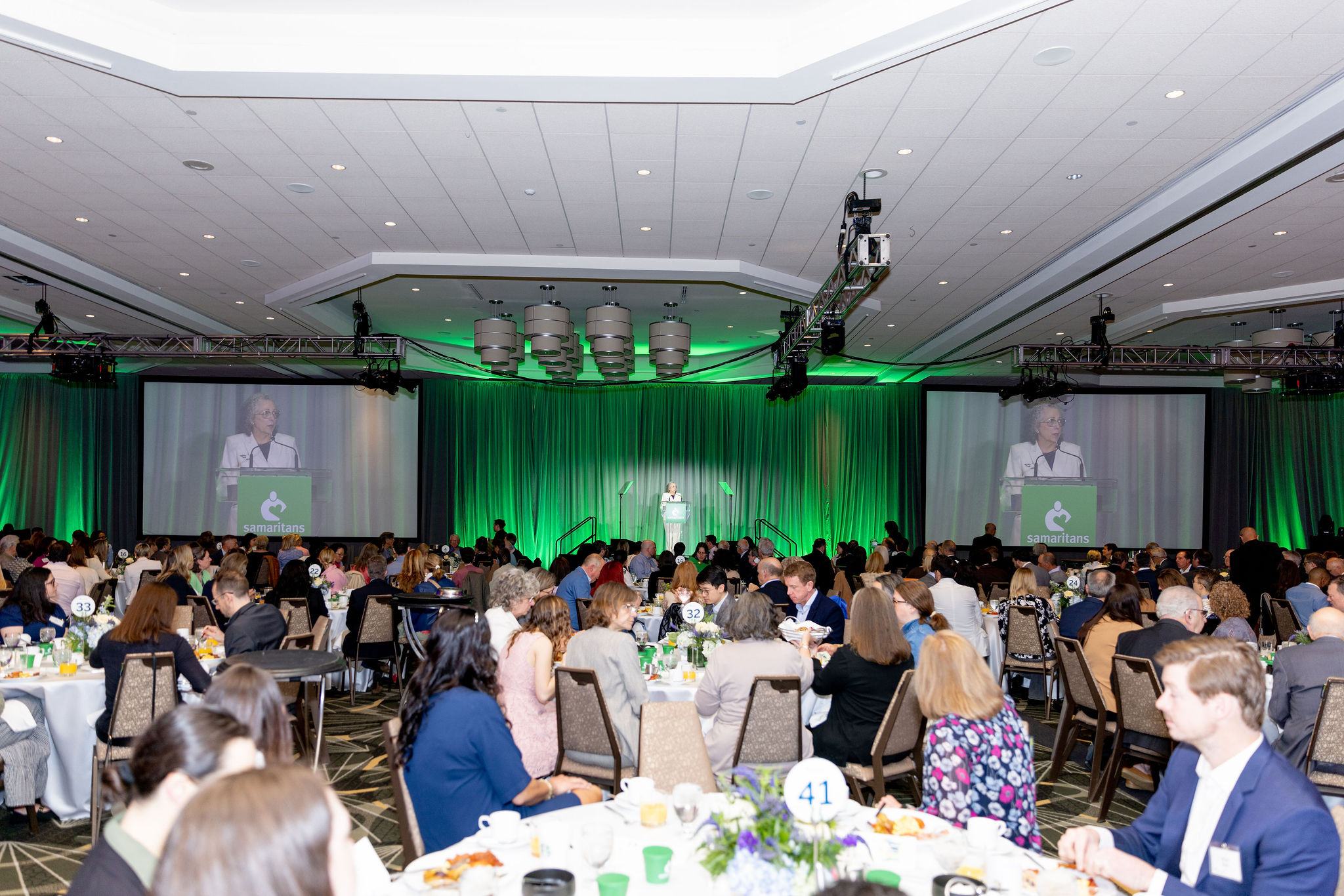 People seated at tables in a ballroom
