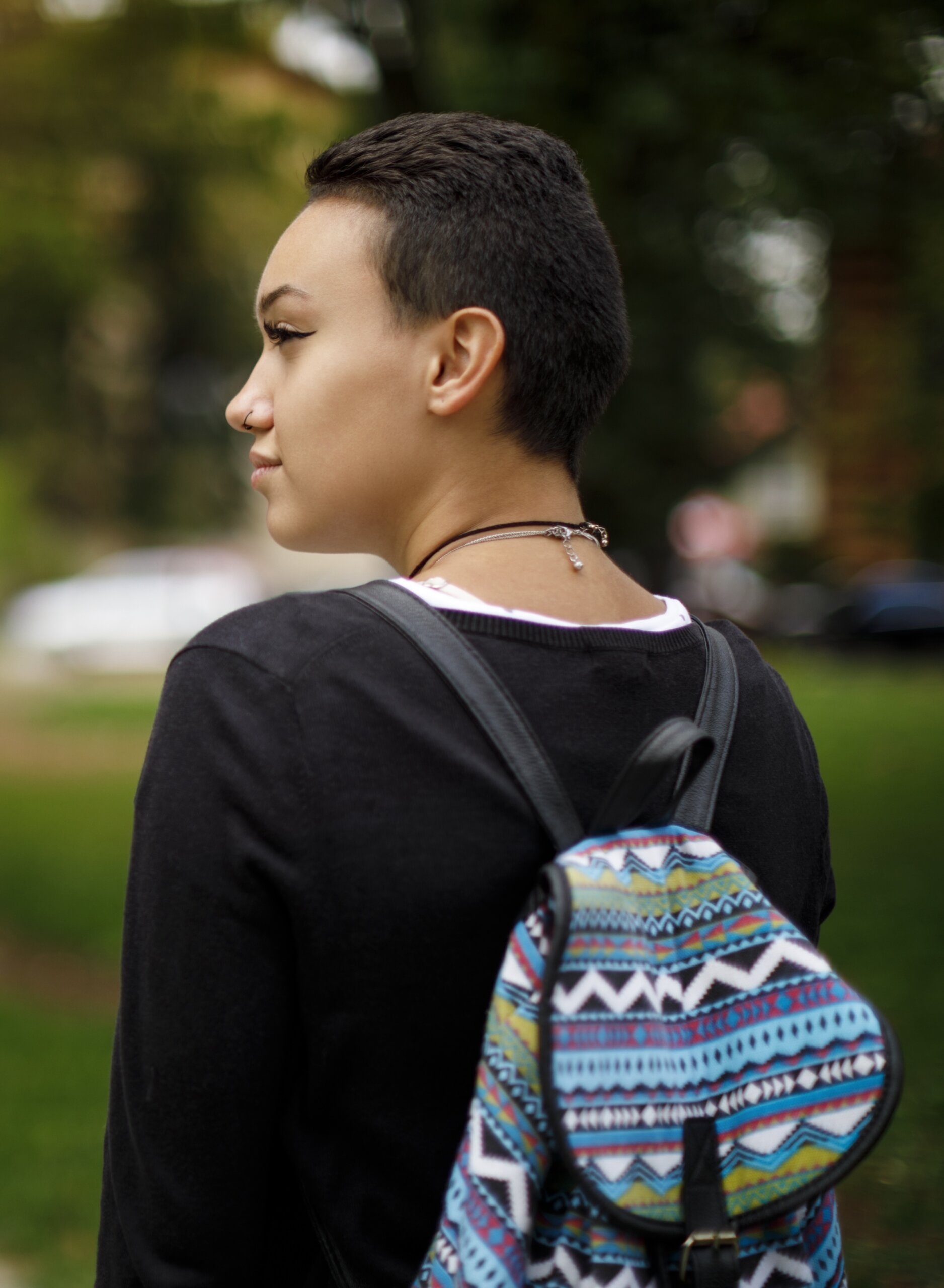 teen sitting outside texting