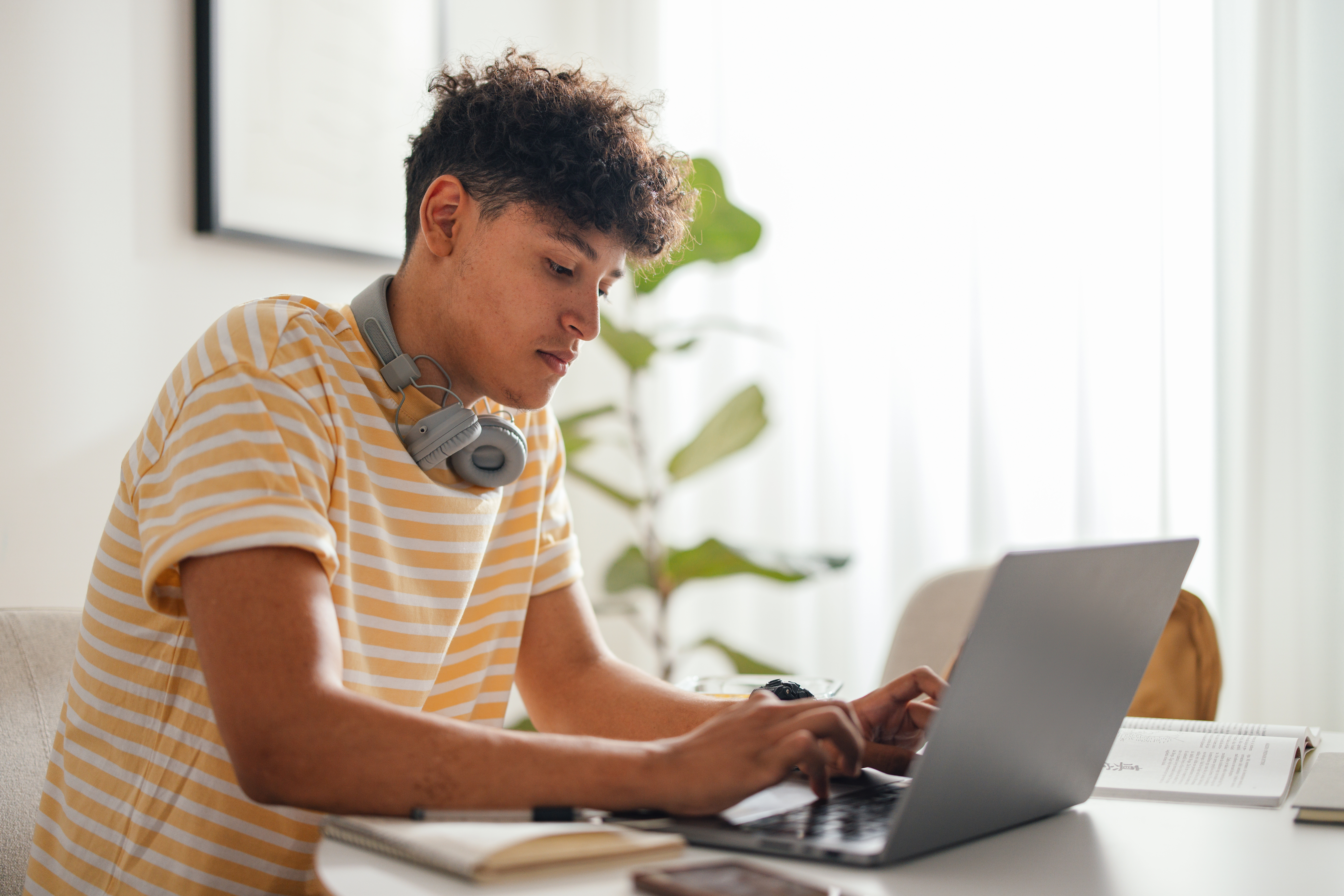 teen sitting outside texting