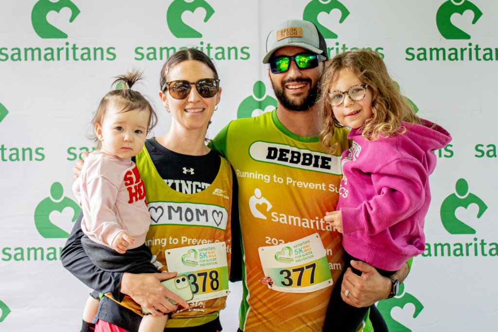 A women and a man standing with two children at the Samaritans 5k 