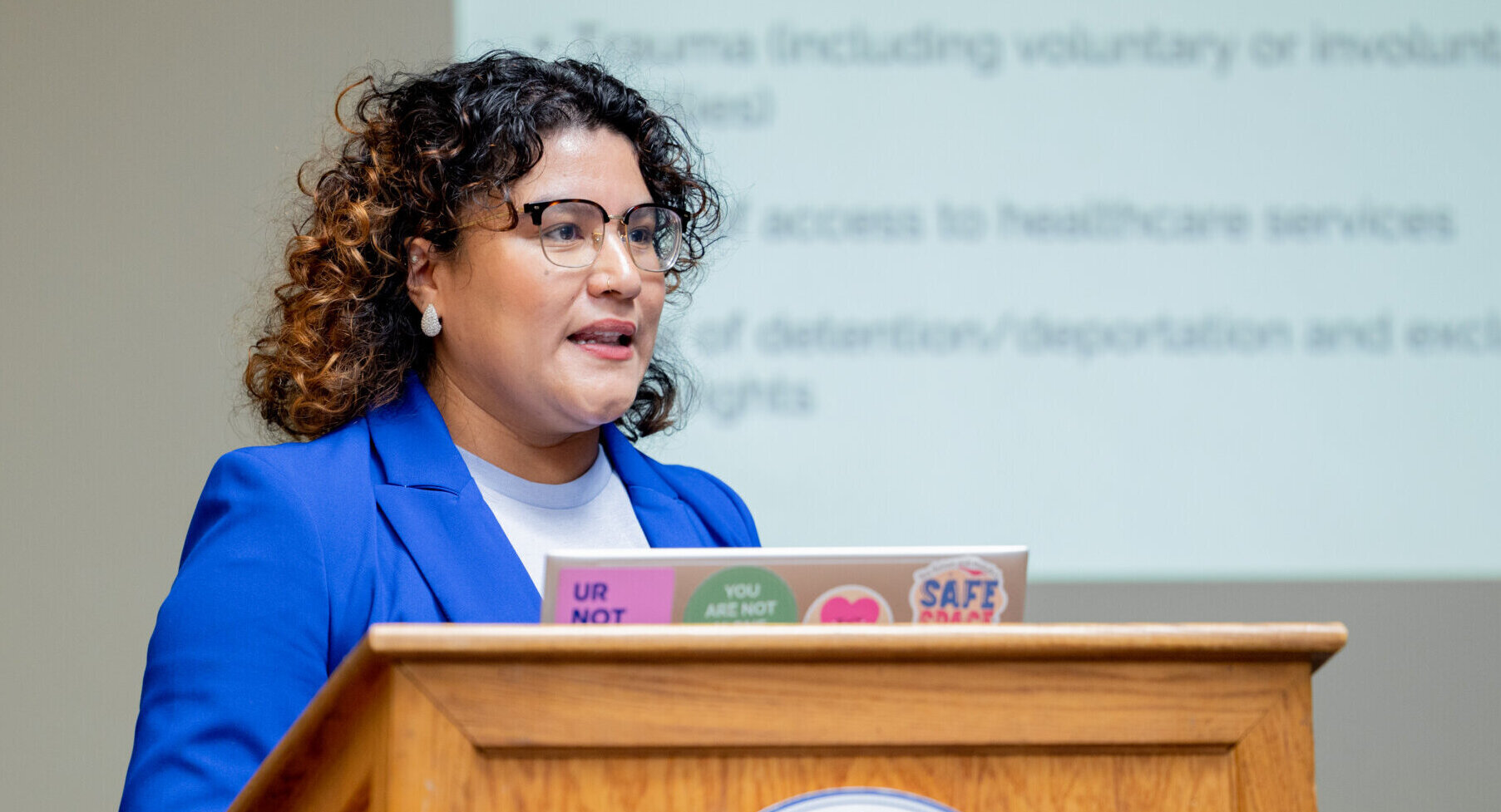 A women speaking at a podium for Samaritans.