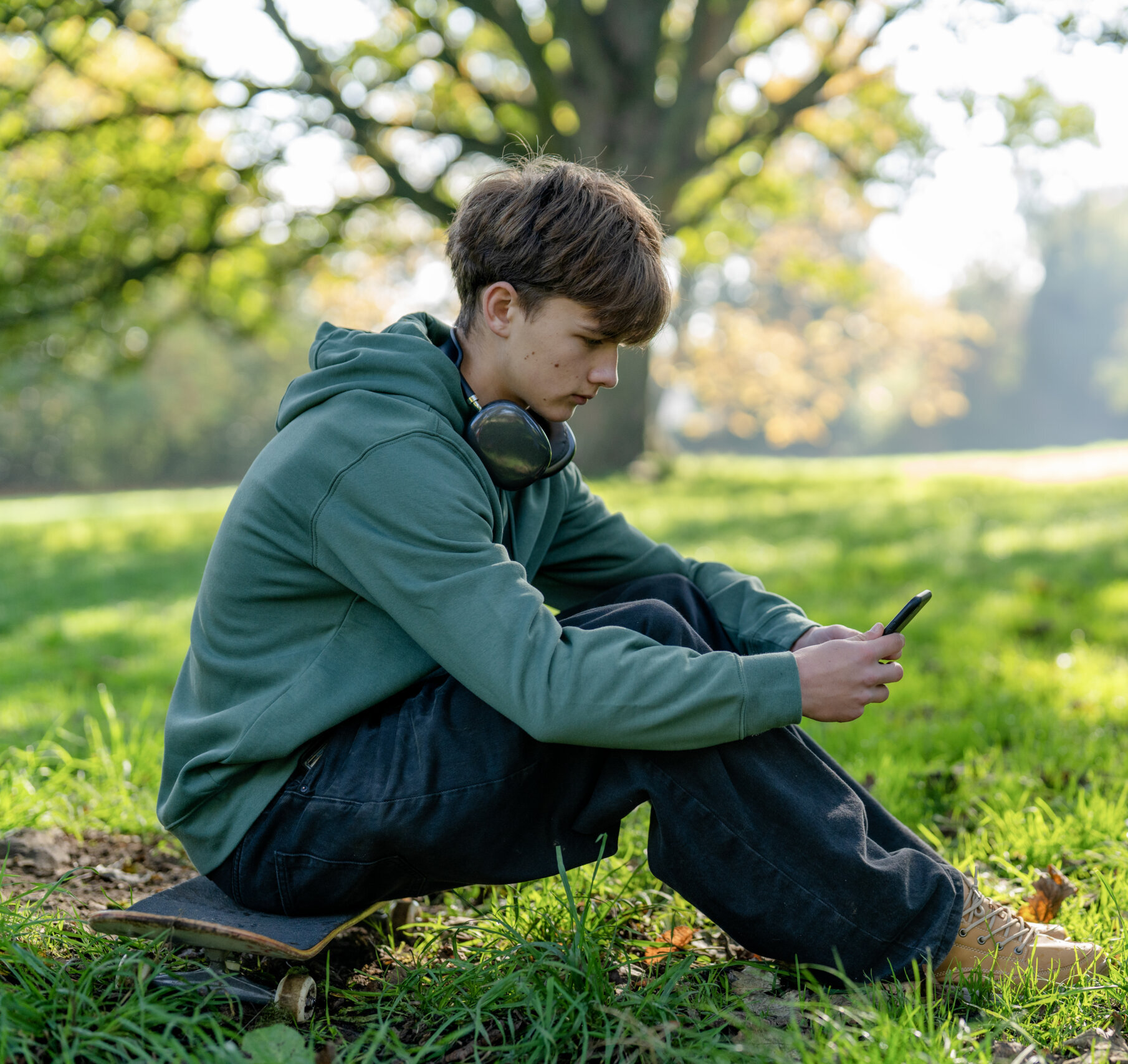 teen sitting outside texting