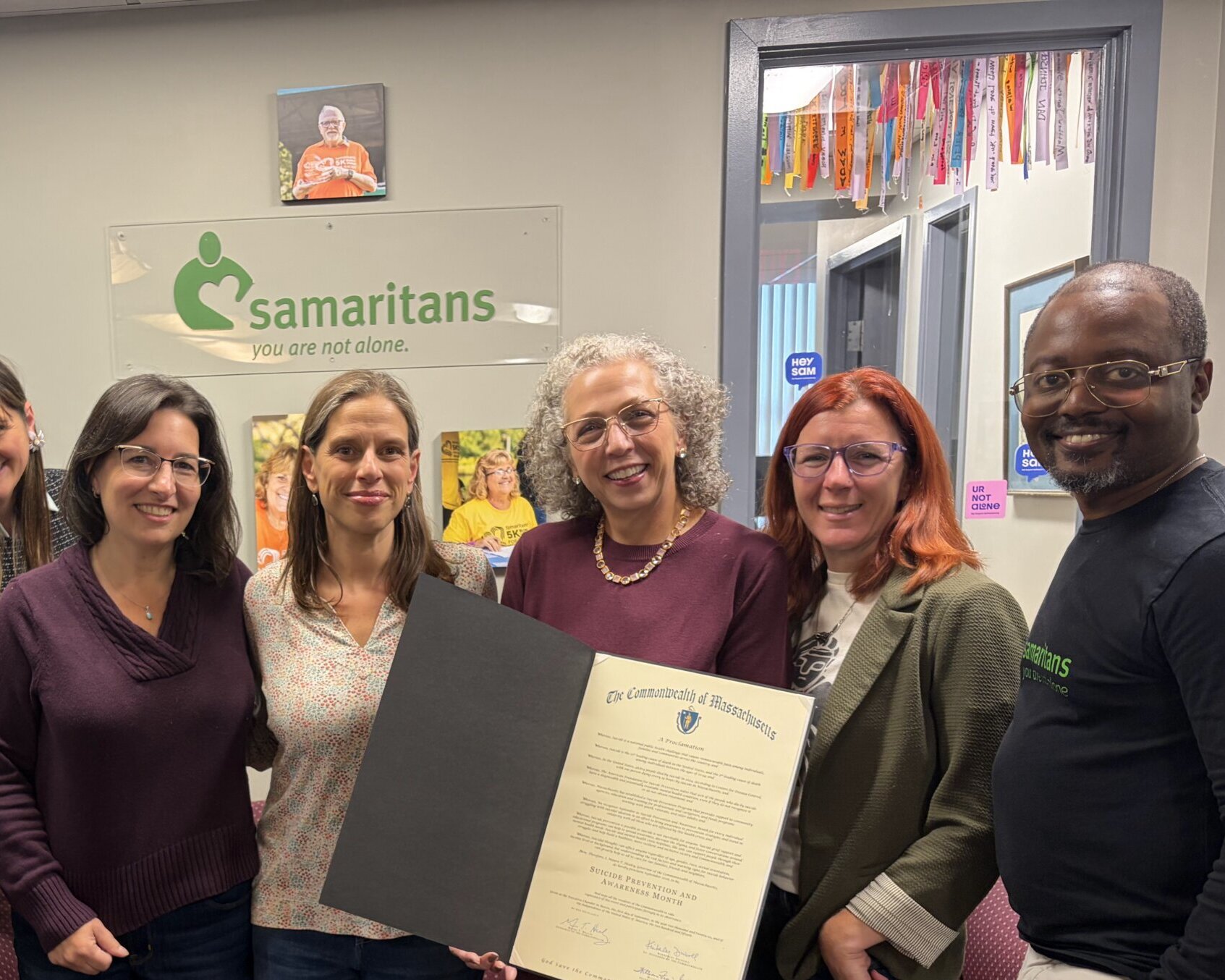 Staff members holding a proclamation