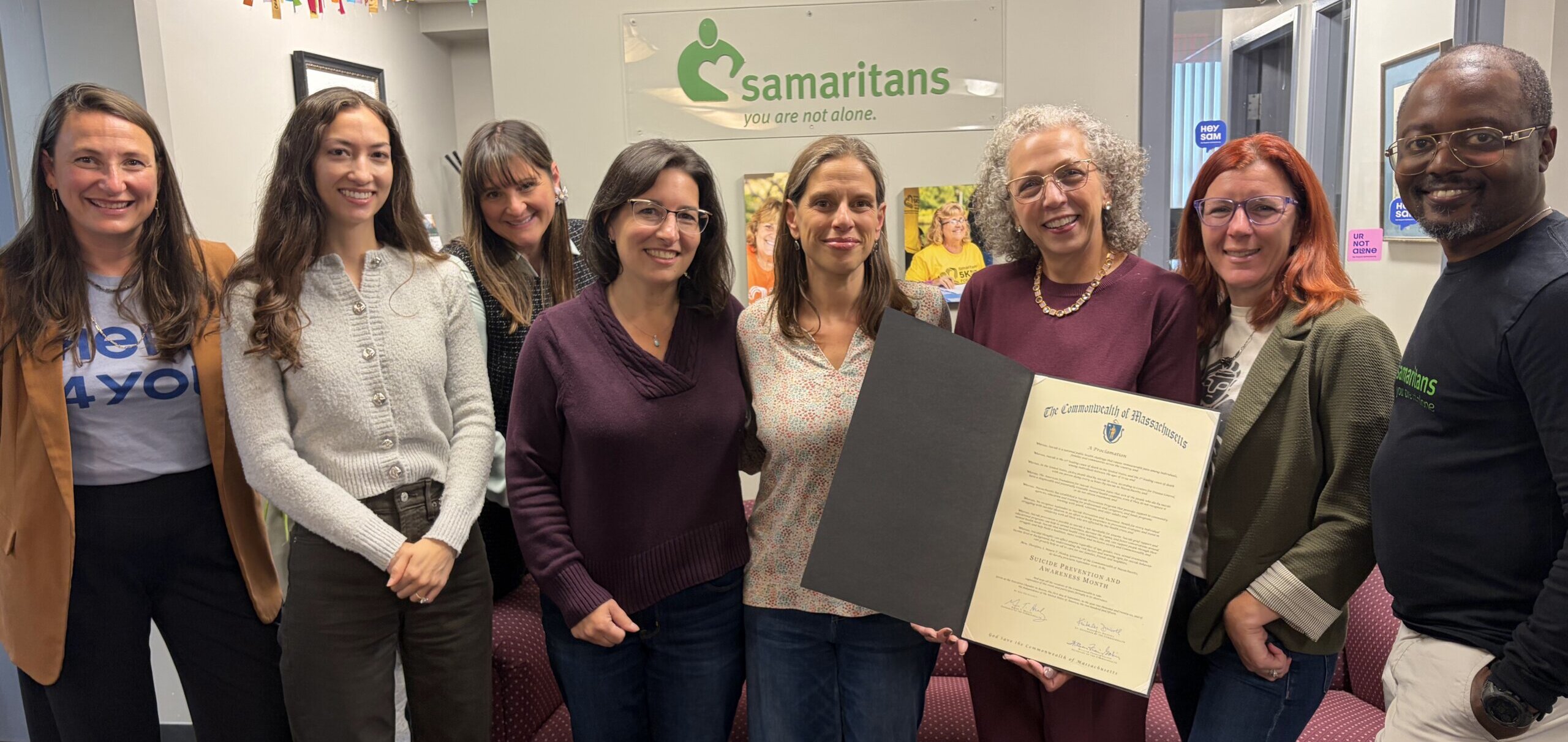 Staff members holding a proclamation