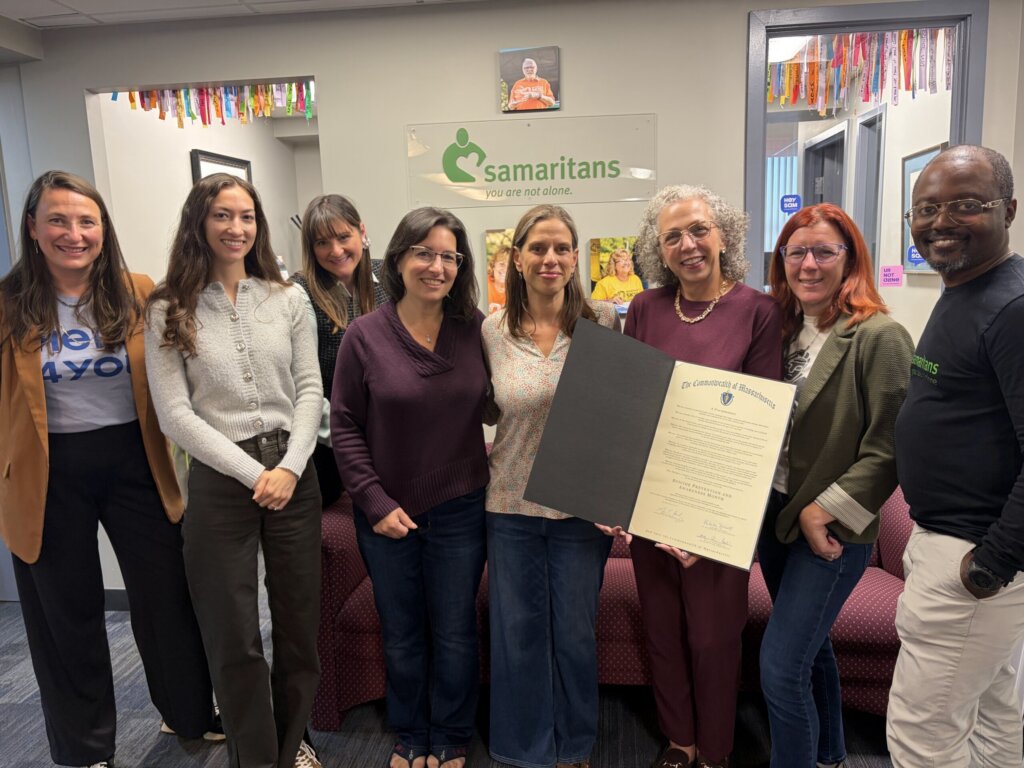 Staff members holding a proclamation