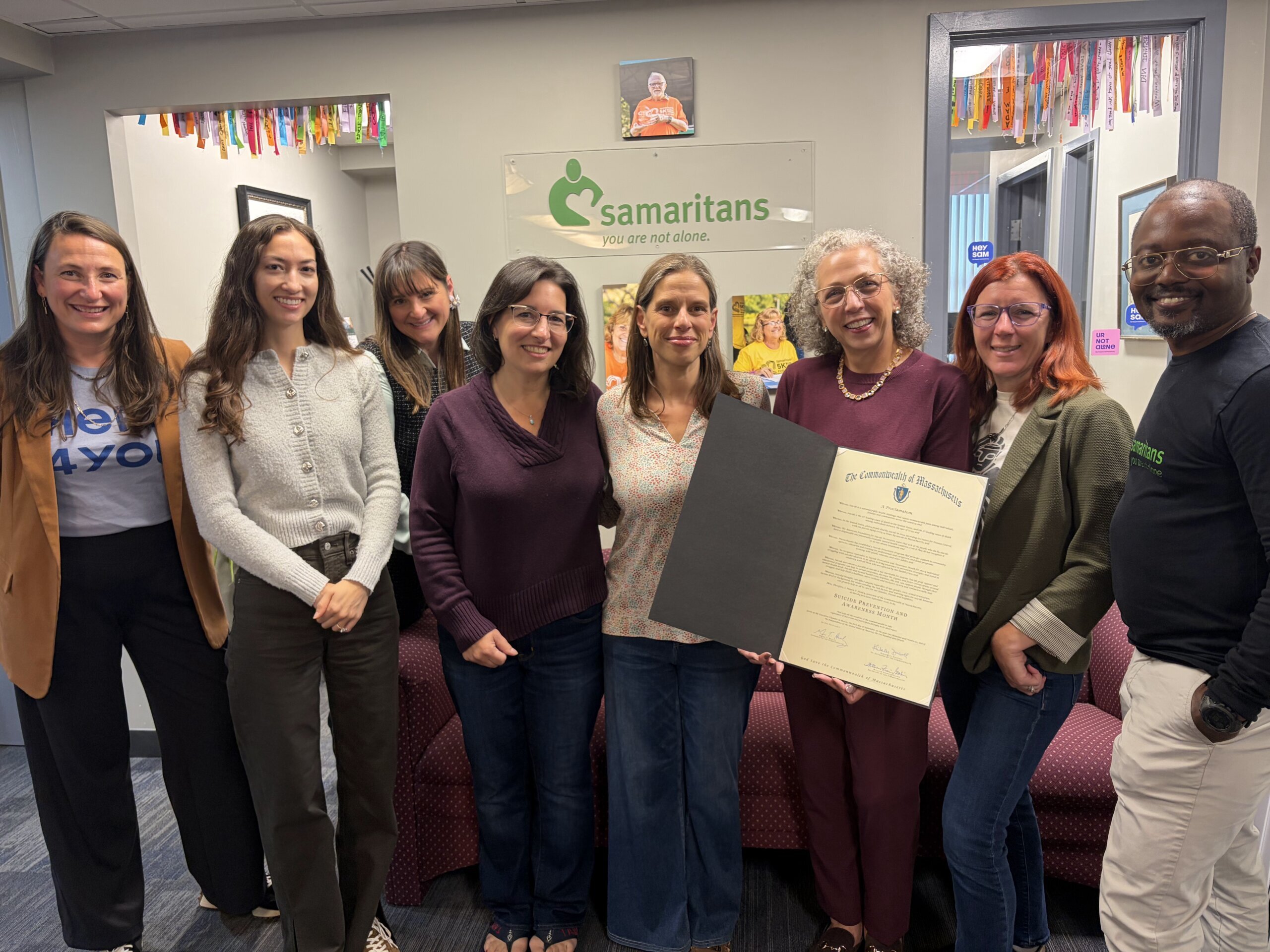 Staff members holding a proclamation